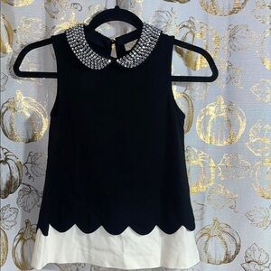 Elegant Black and White Sleeveless Top with Embellished Collar
